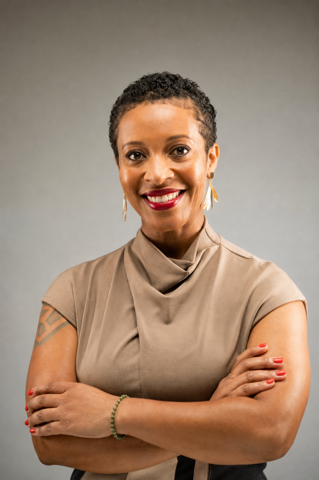 Professional headshot of Lasheika Kassa, Founder and Principal Consultant of Fanik Consulting, smiling with arms crossed
